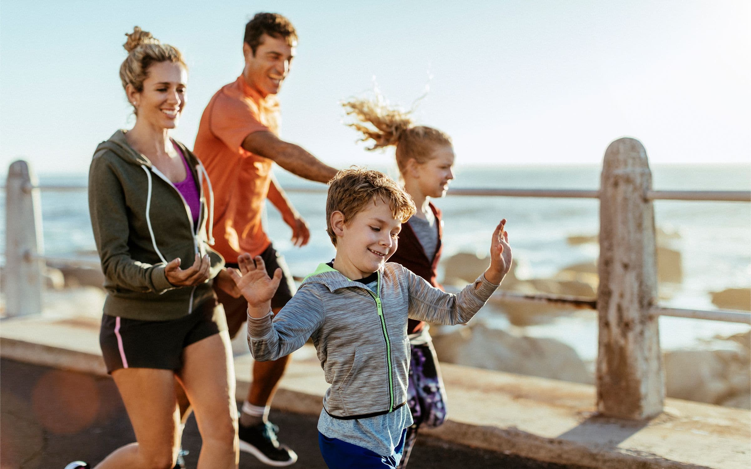 Healthy family taking a stroll at the beach